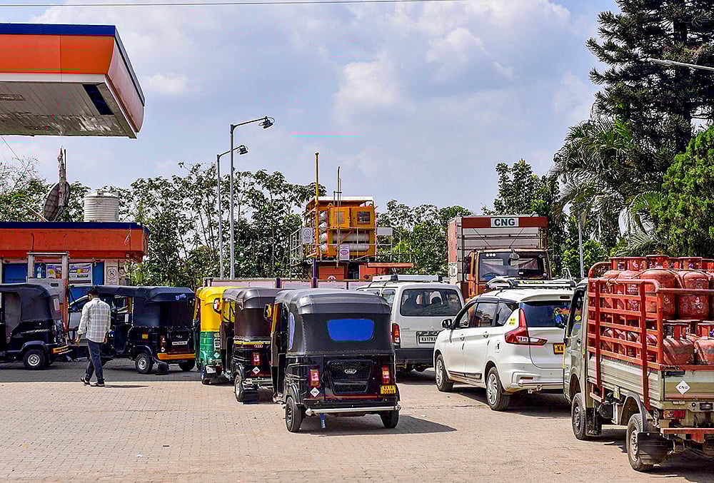 An LPG cylinder carrier truck and other vehicles queue up at a CNG station amid disruptions in supplies due to the ongoing West Asia war, in Chikkamagaluru, Karnataka. - | Photo: PTI