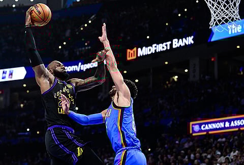 Los Angeles Lakers forward LeBron James (23) shoots against Oklahoma City Thunder guard Ajay Mitchell (25) during the first half of an NBA basketball game in Oklahoma City. 