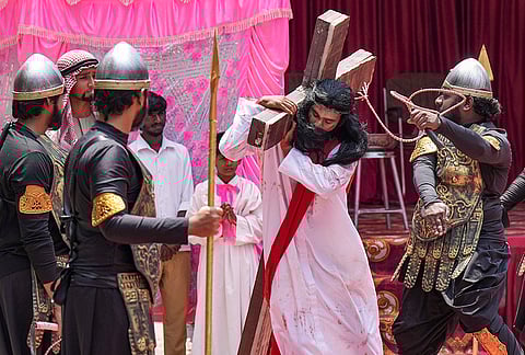 A man dressed as Jesus Christ during a crucifixion reenactment procession on the occasion of Good Friday, in Bengaluru.