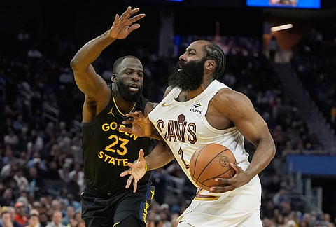 Cleveland Cavaliers guard James Harden, right, drives to the basket against Golden State Warriors forward Draymond Green (23) during the second half of an NBA basketball game in San Francisco.