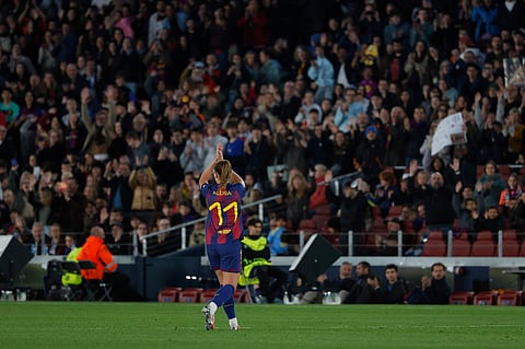 Barcelona's Alexia Putellas applauds supporters during a Champions League quarterfinal soccer match between Barcelona and Real Madrid, in Barcelona, Spain.