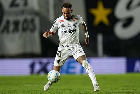 Santos' Neymar carries the ball during a Brazilian soccer league match against Remo in Santos, Brazil.