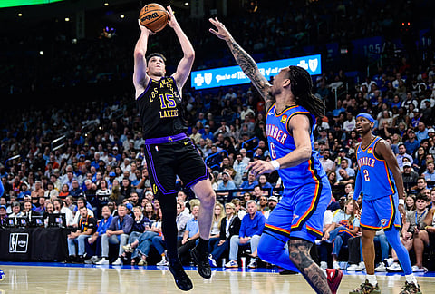 Los Angeles Lakers guard Austin Reaves (15) shoots against Oklahoma City Thunder forward Jaylin Williams (6) during the first half of an NBA basketball game in Oklahoma City.