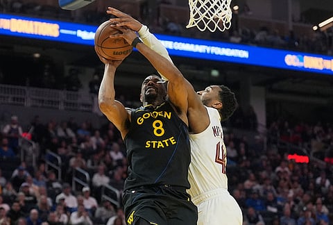 Cleveland Cavaliers guard Donovan Mitchell, right, defends against a shot by Golden State Warriors guard De'Anthony Melton (8) during the first half of an NBA basketball game in San Francisco.