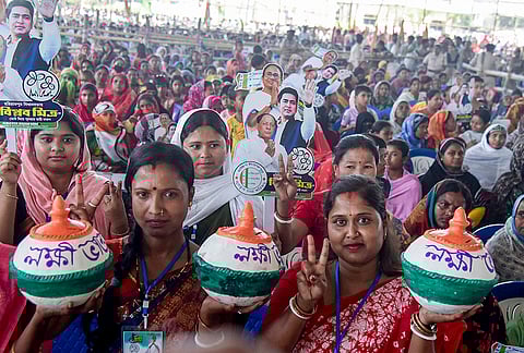 TMC supporters gather during a public meeting led by West Bengal Chief Minister Mamata Banerjee, unseen, ahead of the state Assembly elections, in Dakshin Dinajpur.
