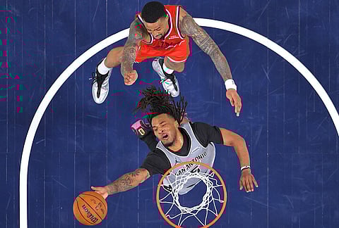 San Antonio Spurs guard Stephon Castle, below, shoots as Los Angeles Clippers forward John Collins defends during the second half of an NBA basketball game in Inglewood, Califoria.