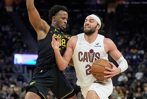 Cleveland Cavaliers guard Max Strus, right, drives to the basket against Golden State Warriors guard LJ Cryer during the second half of an NBA basketball game in San Francisco.