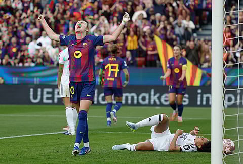 Barcelona's Graham Hansen celebrates after scoring her side's second goal during a Champions League quarterfinal soccer match between Barcelona and Real Madrid, in Barcelona, Spain.