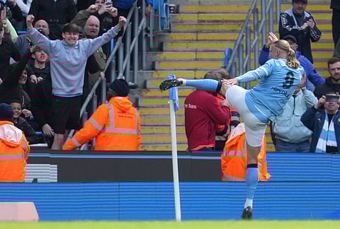Manchester City's Erling Haaland celebrates after scoring during the FA Cup quarter-final soccer match between Manchester City and Liverpool in Manchester, England.