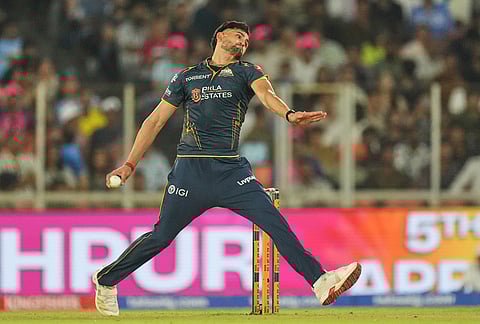 Gujarat Titans' Ashok Sharma bowls a delivery during the Indian Premier League cricket match between Gujarat Titans and Rajasthan Royals in Ahmedabad.