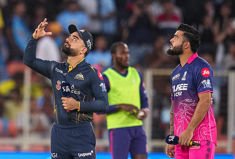 Gujarat Titans' captain Rashid Khan, left, flips the coin as Rajasthan Royals' captain Riyan Parag takes the call during the toss before an Indian Premier League (IPL) 2026 T20 cricket match between Gujarat Titans and Rajasthan Royals, in Ahmedabad, Gujarat. - | Photo: PTI/Kamal Kishore