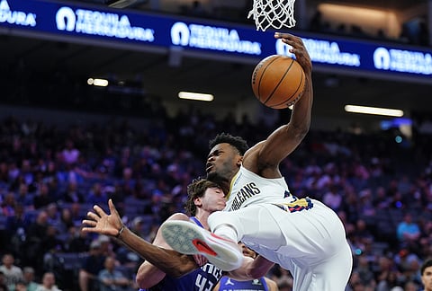 New Orleans Pelicans center Yves Missi, right, is fouled by Sacramento Kings center Maxime Raynaud, left, during the first half of an NBA basketball game in Sacramento, California.