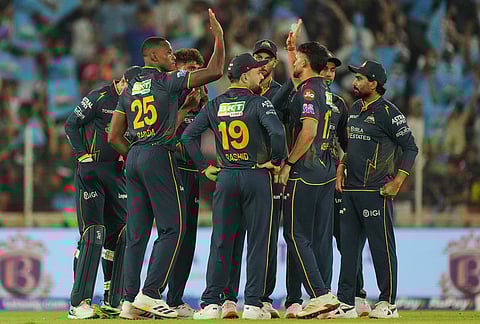 Gujarat Titans' Kagiso Rabada, second left, celebrates with teammates the wicket of Rajasthan Royals' Yashasvi Jaiswal during the Indian Premier League cricket match between Gujarat Titans and Rajasthan Royals in Ahmedabad.