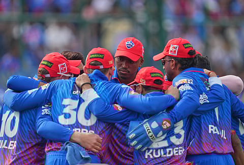 Delhi Capitals' Lungi Ngidi, center facing camera, huddles with others before the start of the Indian Premier League cricket match between Delhi Capitals and Mumbai Indians in New Delhi.