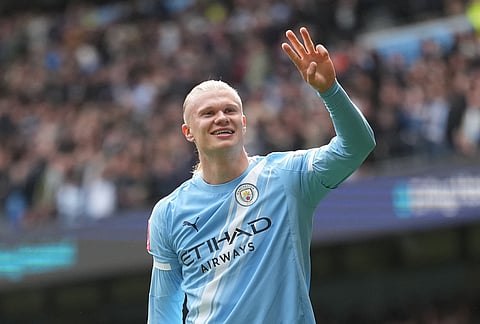 Manchester City's Erling Haaland celebrates after scoring his third goal during the FA Cup quarter-final soccer match between Manchester City and Liverpool in Manchester, England.