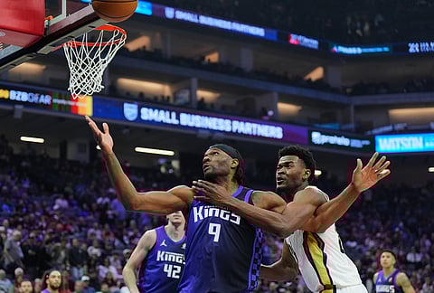 Sacramento Kings forward Precious Achiuwa (9) fights for a rebound against New Orleans Pelicans center Yves Missi, right, during the first half of an NBA basketball game in Sacramento, California. 