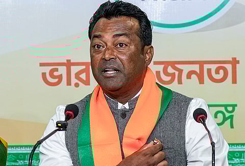 Former tennis player Leander Paes shows his badge during a press conference, at BJP office in Kolkata, West Bengal.