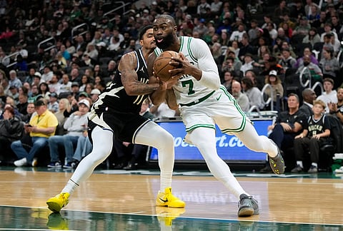 Boston Celtics' Jaylen Brown (7) drives to the basket against Milwaukee Bucks' Gary Harris during the second half of an NBA basketball game in Milwaukee.