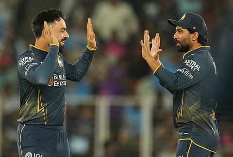 Gujarat Titans' Rashid Khan, left, and Rahul Tewatia celebrates the wicket of Rajasthan Royals’ Vaibhav Sooryavanshi during the Indian Premier League cricket match between Gujarat Titans and Rajasthan Royals in Ahmedabad.