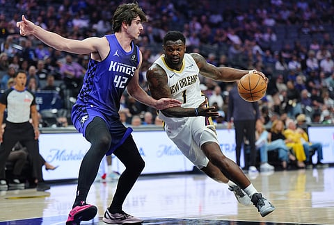 New Orleans Pelicans forward Zion Williamson (1) drives to the basket against Sacramento Kings center Maxime Raynaud (42) during the first half of an NBA basketball game in Sacramento, California.