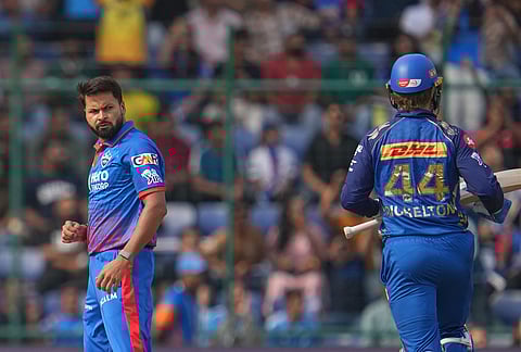 Delhi Capitals' Mukesh Kumar, left, looks at Mumbai Indians' Ryan Rickelton following a delivery during the Indian Premier League cricket match between Delhi Capitals and Mumbai Indians in New Delhi.