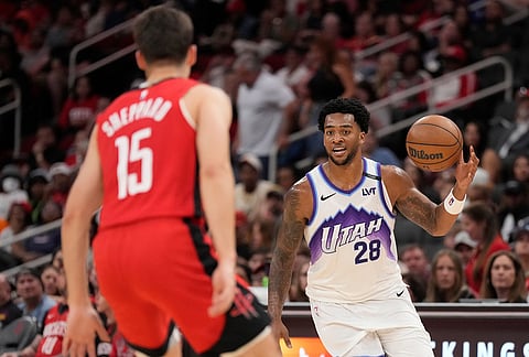 Utah Jazz forward Brice Sensabaugh (28) controls the ball against Houston Rockets guard Reed Sheppard (15) during the second half of an NBA basketball game, in Houston.