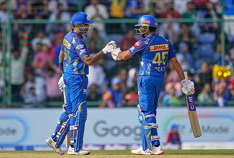 Mumbai Indians' Suryakumar Yadav, left, and Rohit Sharma bump fists after scoring runs during the Indian Premier League cricket match between Delhi Capitals and Mumbai Indians in New Delhi.