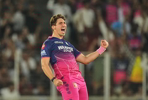 Rajasthan Royals' Nandre Burger celebrates the wicket of Gujarat Titans' Jos Buttler during the Indian Premier League cricket match between Gujarat Titans and Rajasthan Royals in Ahmedabad.