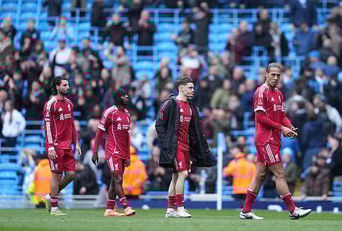 Liverpool players walk off the pitch after the FA Cup quarter-final soccer match between Manchester City and Liverpool in Manchester, England.