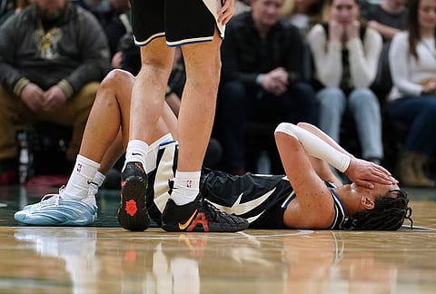 Milwaukee Bucks' Ousmane Dieng reacts after suffering an injury during the second half of an NBA basketball game against the Boston Celtics in Milwaukee. Dieng did not return to the game.