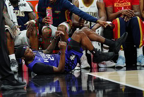 Sacramento Kings guard Daeqwon Plowden (29) lays on the court after trying to save a ball from going out of bounds during the second half of an NBA basketball game against the New Orleans Pelicans in Sacramento, California. 