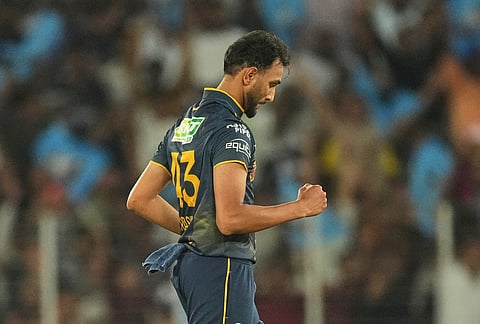 Gujarat Titans' Prasidh Krishna celebrates the wicket of Rajasthan Royals' captain Riyan Parag during the Indian Premier League cricket match between Gujarat Titans and Rajasthan Royals in Ahmedabad.