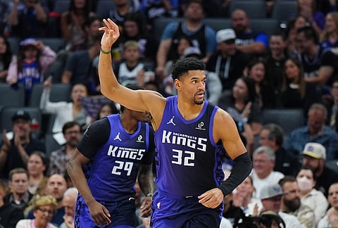 Sacramento Kings center Dylan Cardwell (32) gestures after making a basket during the first half of an NBA basketball game against the New Orleans Pelicans, in Sacramento, California.