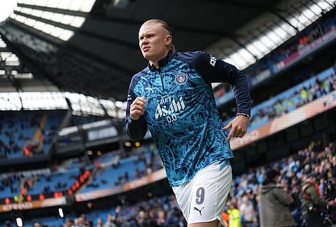 Manchester City's Erling Haaland enters the pitch before the FA Cup quarter-final soccer match between Manchester City and Liverpool in Manchester, England.