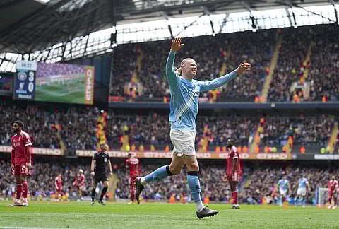 Manchester City's Erling Haaland celebrates after scoring his third goal during the FA Cup quarter-final soccer match between Manchester City and Liverpool in Manchester, England.