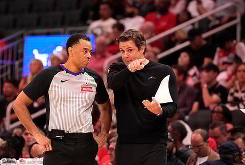 Utah Jazz head coach Will Hardy, right, talks with referee Karl Lane, left, during the second half of an NBA basketball game against the Houston Rockets, in Houston. 