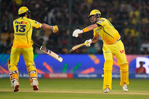 Chennai Super Kings' Prashant Veer, left, moves to touch gloves with batting partner Jamie Overton during the Indian Premier League cricket match between Chennai Super Kings and Royal Challengers Bengaluru in Bengaluru, India.