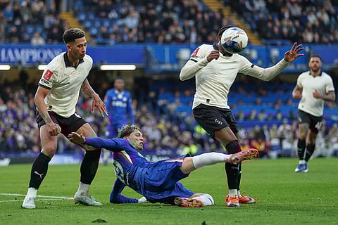 Chelsea's Alejandro Garnacho, centre, challenges for the ball with Port Vale's Jordan Lawrence-Gabriel, left, and Port Vale's Ethon Archer during the English FA Cup quarterfinal soccer match between Chelsea and Port Vale in London, England.