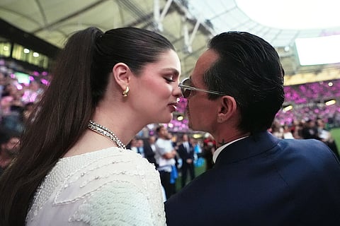 Marc Anthony, right, kisses his wife Nadia Ferreira, left, before singing the national anthem at an MLS soccer match between Inter Miami CF and Austin FC  in Miami.