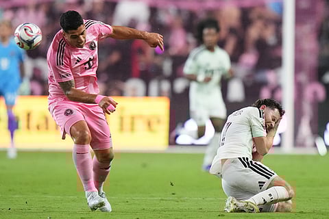 Inter Miami CF forward Luis Suárez,left, heads the ball as Austin FC defender Jon Gallagher, right, reacts during the second half of an MLS soccer match in Miami.