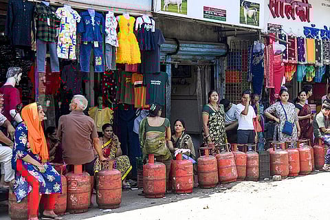People wait in a queue to refill LPG cylinders amid disruptions due to the ongoing West Asia war, in Mumbai, Maharashtra.