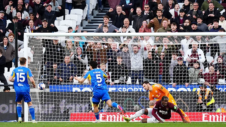West Ham United's Axel Disasi, center right, scores their side's second goal during their English FA Cup, quarter-final soccer match against Leeds United in London, Sunday, April 5, 2026. - (John Walton/PA via AP)