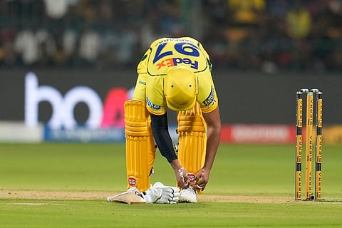 Chennai Super Kings' Sarfaraz Khan ties his shoelace during the Indian Premier League cricket match between Chennai Super Kings and Royal Challengers Bengaluru in Bengaluru, India.
