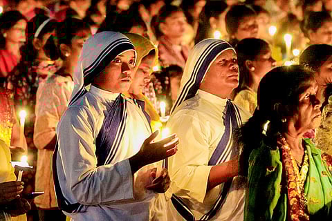 Nuns light candles as they take part in a midnight mass prayer on Easter, at Loyola Ground, in Ranchi, Jharkhand.