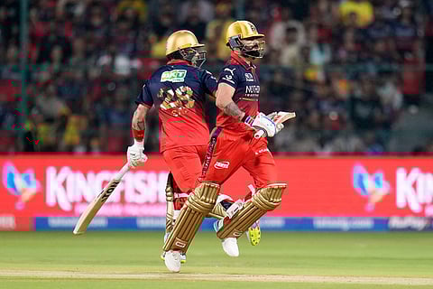 Royal Challengers Bengaluru's Virat Kohli, right, and batting partner Phil Salt run between the wickets during the Indian Premier League cricket match between Chennai Super Kings and Royal Challengers Bengaluru in Bengaluru, India.
