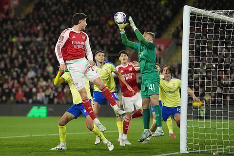 Southampton's goalkeeper Daniel Peretz saves a shot by Arsenal's Kai Havertz, left, during the English FA Cup quaterfinal soccer match between Southampton and Arsenal in Southampton, England.