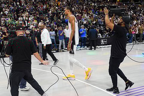 San Antonio Spurs center Victor Wembanyama walks off the floor after losing in overtime of an NBA basketball game to the Denver Nuggets in Denver.