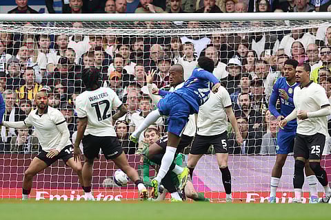 Chelsea's Jorrel Hato, centre, scores his side's opening goal during the English FA Cup quarterfinal soccer match between Chelsea and Port Vale in London, England.