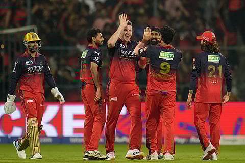 Royal Challengers Bengaluru's players celebrate the wicket of Chennai Super Kings' Kartik Sharma during the Indian Premier League cricket match between Chennai Super Kings and Royal Challengers Bengaluru in Bengaluru, India.