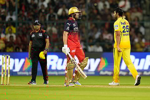 Chennai Super Kings' Shivam Dube, right, reacts after taking the wicket of Royal Challengers Bengaluru's Phil Salt, center, during the Indian Premier League cricket match between Chennai Super Kings and Royal Challengers Bengaluru in Bengaluru, India.